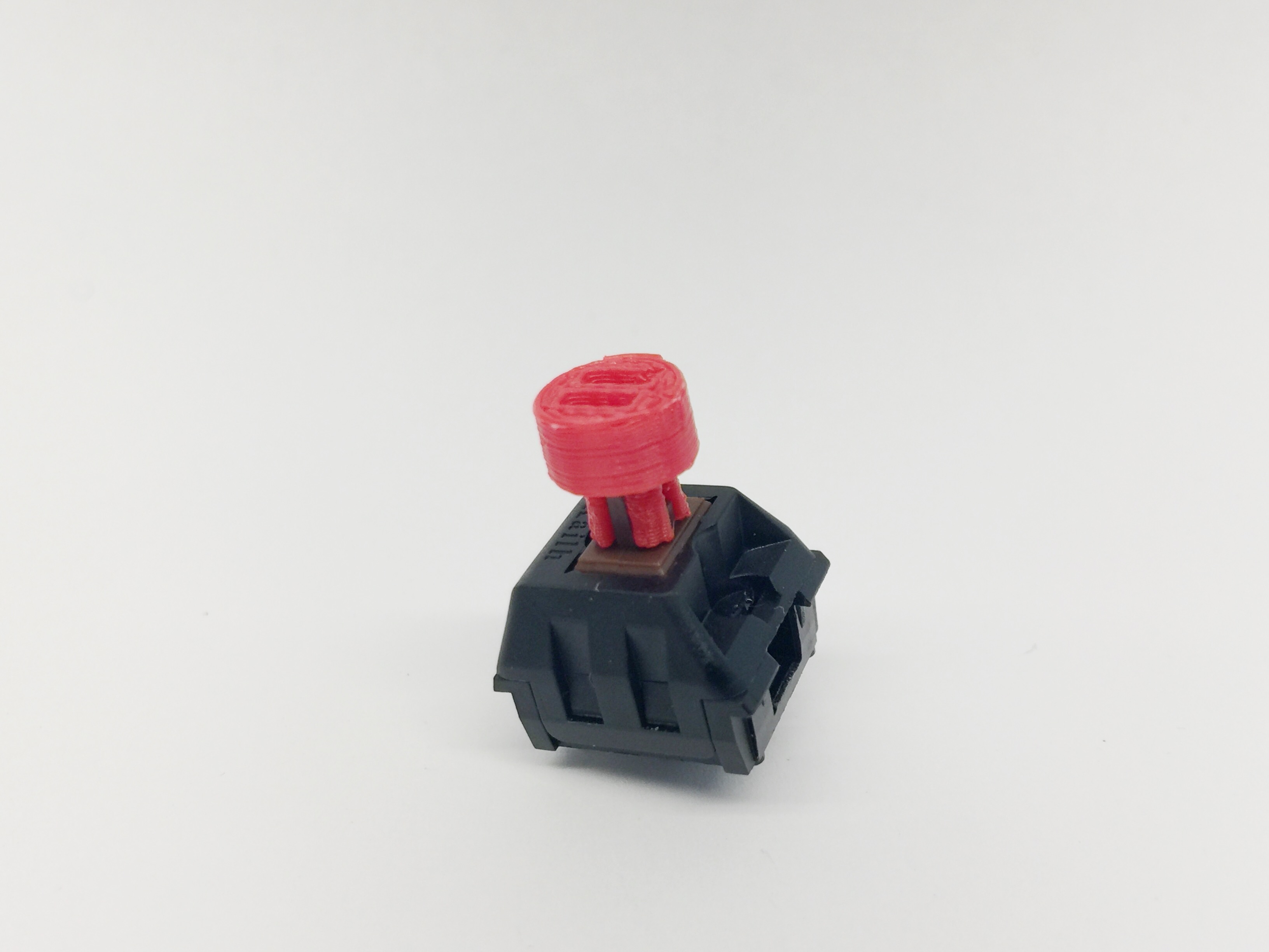 Adapter test-fitted on a Kailh brown-switch. The print result wasn't the best, so the adapter is quite fragile, but it does the job as proof of concept.