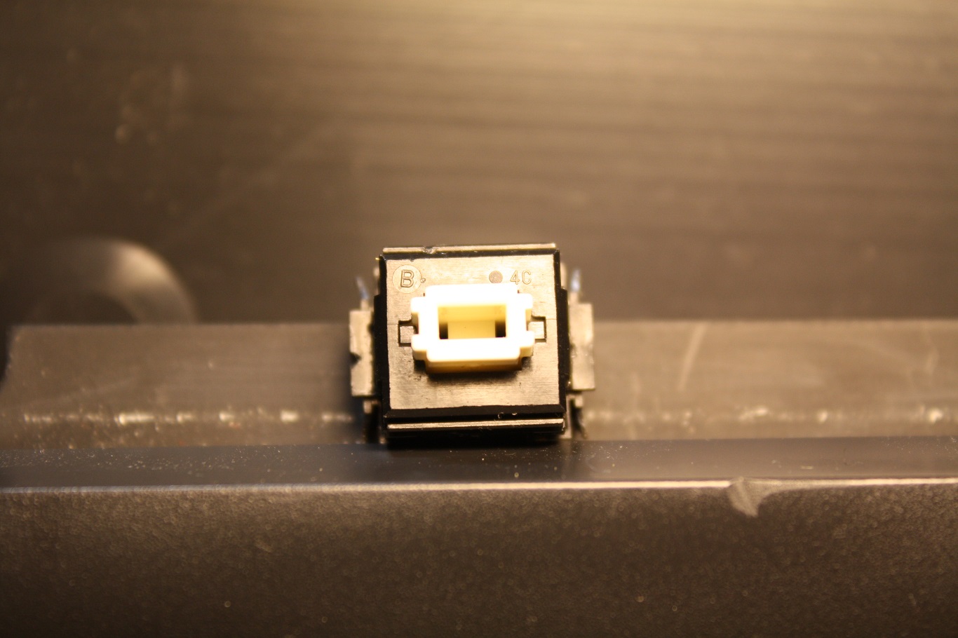 NeXT Non-ADB - AAE Alps key switch markings "B" and "4C".  Zooming in on high-rez original, the dot to the left of the "4C" is nothing.